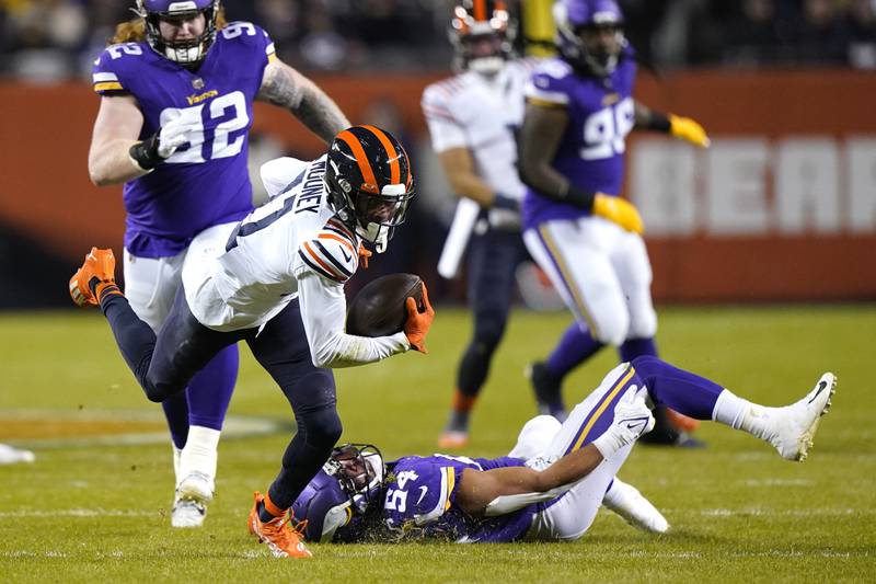 Chicago Bears wide receiver Darnell Mooney advances the ball off a pass from quarterback Justin Fields against the Minnesota Vikings on Dec. 20, 2021, in Chicago.