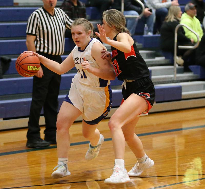 Sandwich's Morgan Potter (11) runs down the court as Sandwich's Kaylin Herren (22) guards her n the Tim Humes Breakout Tournament on Friday, Nov. 18, 2022 in Somonauk.