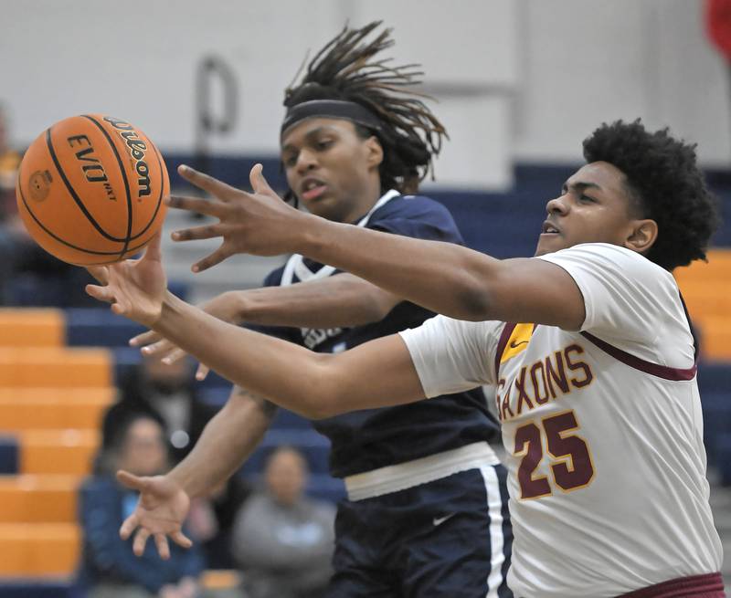 Schaumburg’s Zion Young and Downers Grove South’s Keon Maggitt battle for the ball in a boys basketball game in Buffalo Grove on Friday, January 3, 2025.
