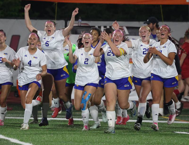 Johnsburg players run onto the field as time ticks away in their 2-1 win over Timothy Christian Thursday, June 5, 2025, during their IHSA Class 1A state semifinal game at North Central College in Naperville.