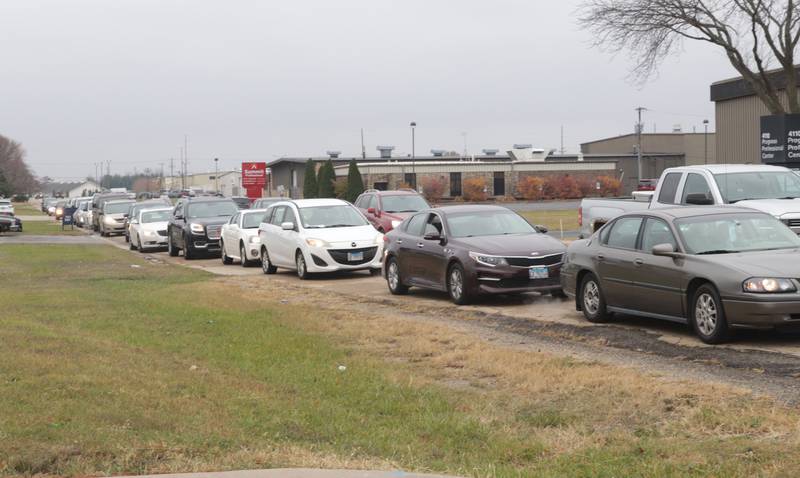 A long line of cars wait for orders on Progress Boulevard during the Thanksgiving Distribution on Wednesday, Nov. 19, 2025 at the Illinois Valley Food Pantry in Peru. Nearly 500 families or roughly 1,200 people in the Illinois Valley got a Thanksgiving meal.