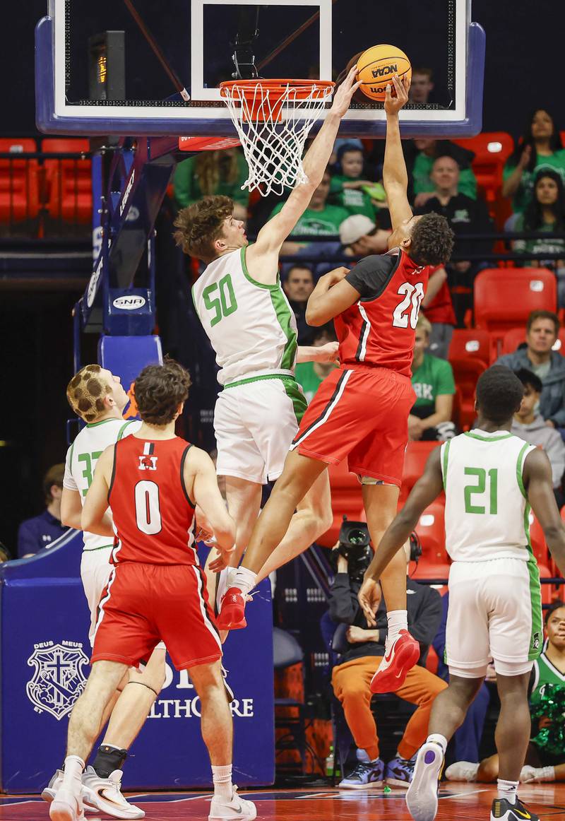 York’s Hunter Stepanich (50) blocks a shot but Marist's Kendall Meyers (20) during the IHSA Class 4A boys basketball state semifinal Friday, March 13, 2026 at the State Farm Center in Champaign.