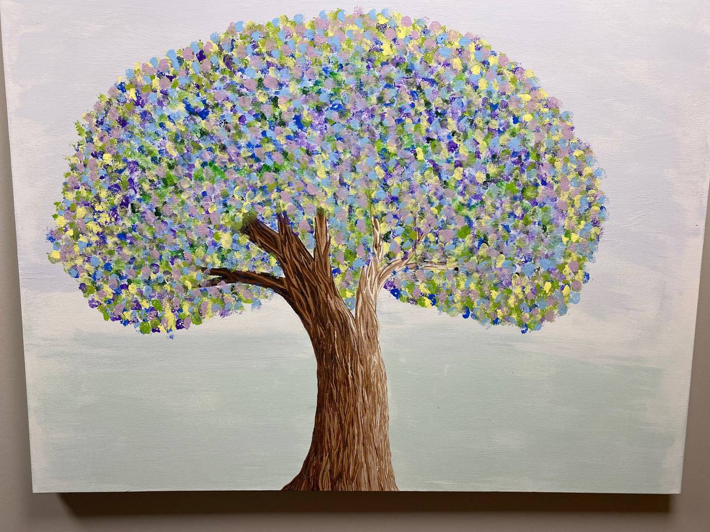 Two trees painted by staff at the Radiation Therapy Center are on display on either side of the Tree of Hope.