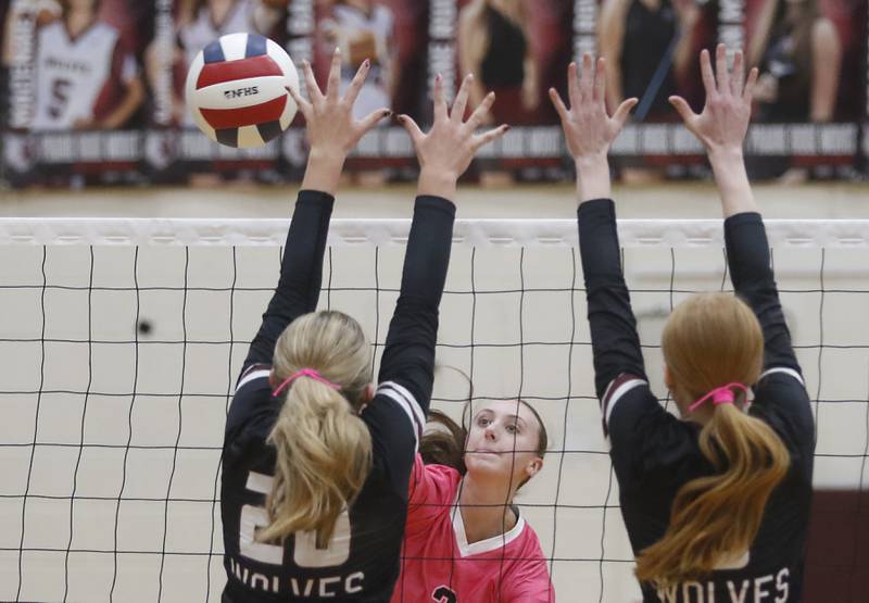 Huntley's Rachael Hein (center) hits the ball away from the block Prairie Ridge's Ava Bell (left) and Sonora Bekere during a Fox Valley Conference volleyball match on Tuesday, Oct. 14, 2025, at the Prairie Ridge High School in Crystal Lake.