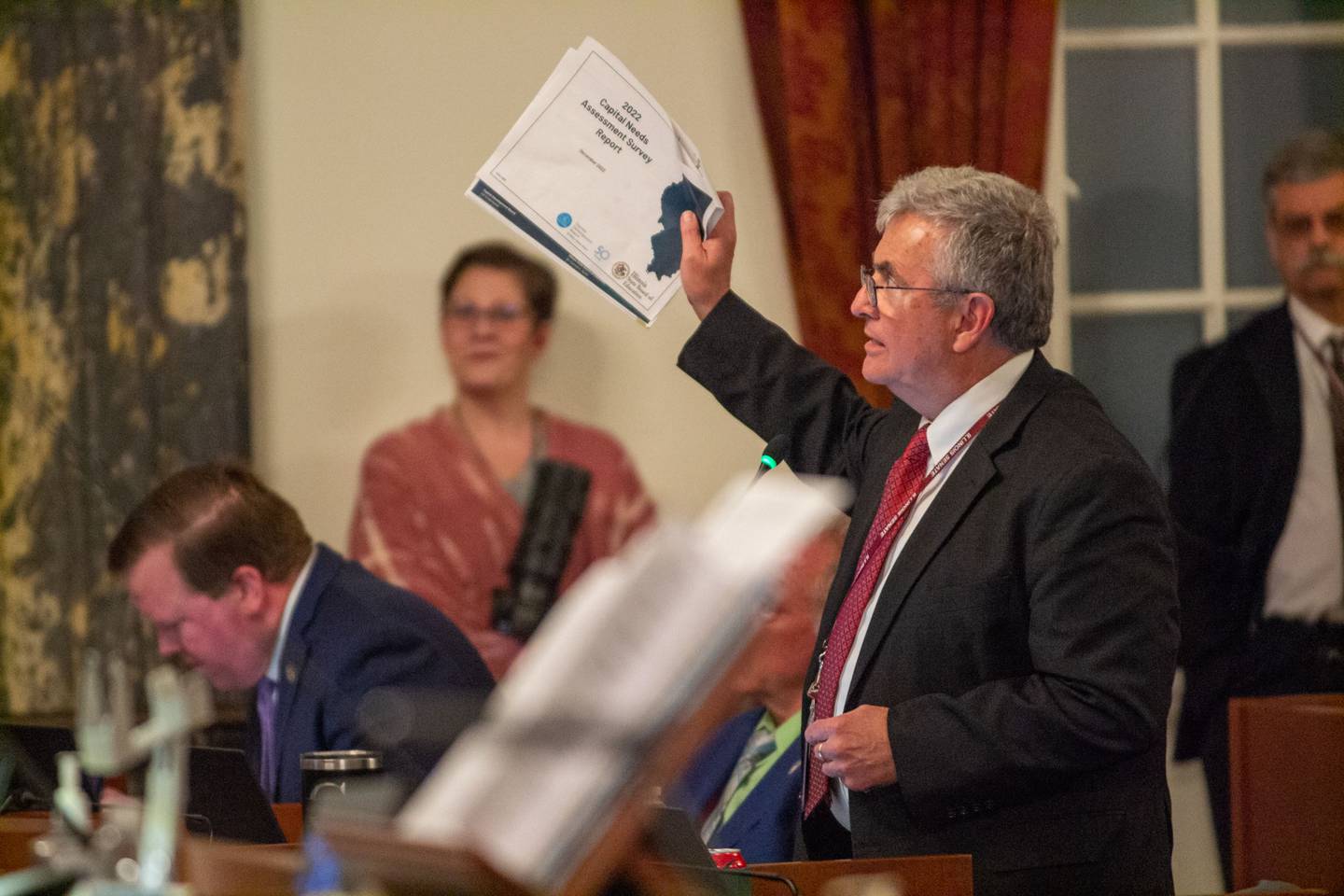 Sen. Tom Bennett, R-Gibson City, holds up a capital needs assessment for school districts, criticizing Democrats for not allocating more money to K-12 capital projects in their $53.1 billion budget proposal.