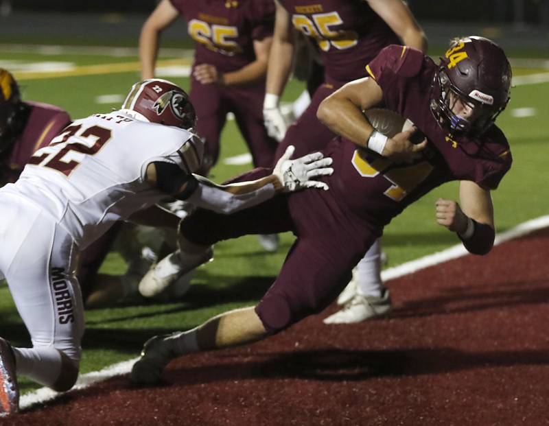 Richmond-Burton's Toby Quentrall-Quezada, right, dives into he end zone in front of Morris’ Will Knapp to score a touchdown during a Kishwaukee River Conference / Interstate 8 Conference crossover football game Friday, Sept. 30, 2022, between Richmond-Burton and Morris at Richmond-Burton Community High School in Richmond.