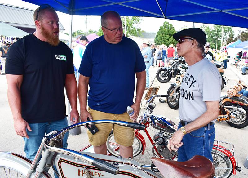 Derek Heslop (left) and Dan Heslop of Sterling listen to information about a 1912 Harley-Davidson motorcycle from owner Devon Pritchard from Pontiac on Sunday, Aug. 24, 2025, in Amboy.