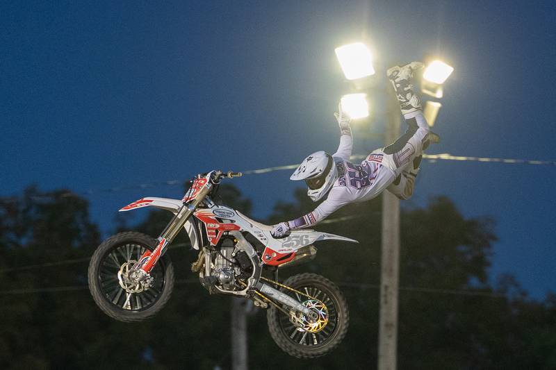 Alex Damlow performs the 'Superman Seat Grab' trick during the FMX segment of the Monster Truck Bash show on Saturday, Sept. 13, 2025 at the La Salle Speedway in La Salle.