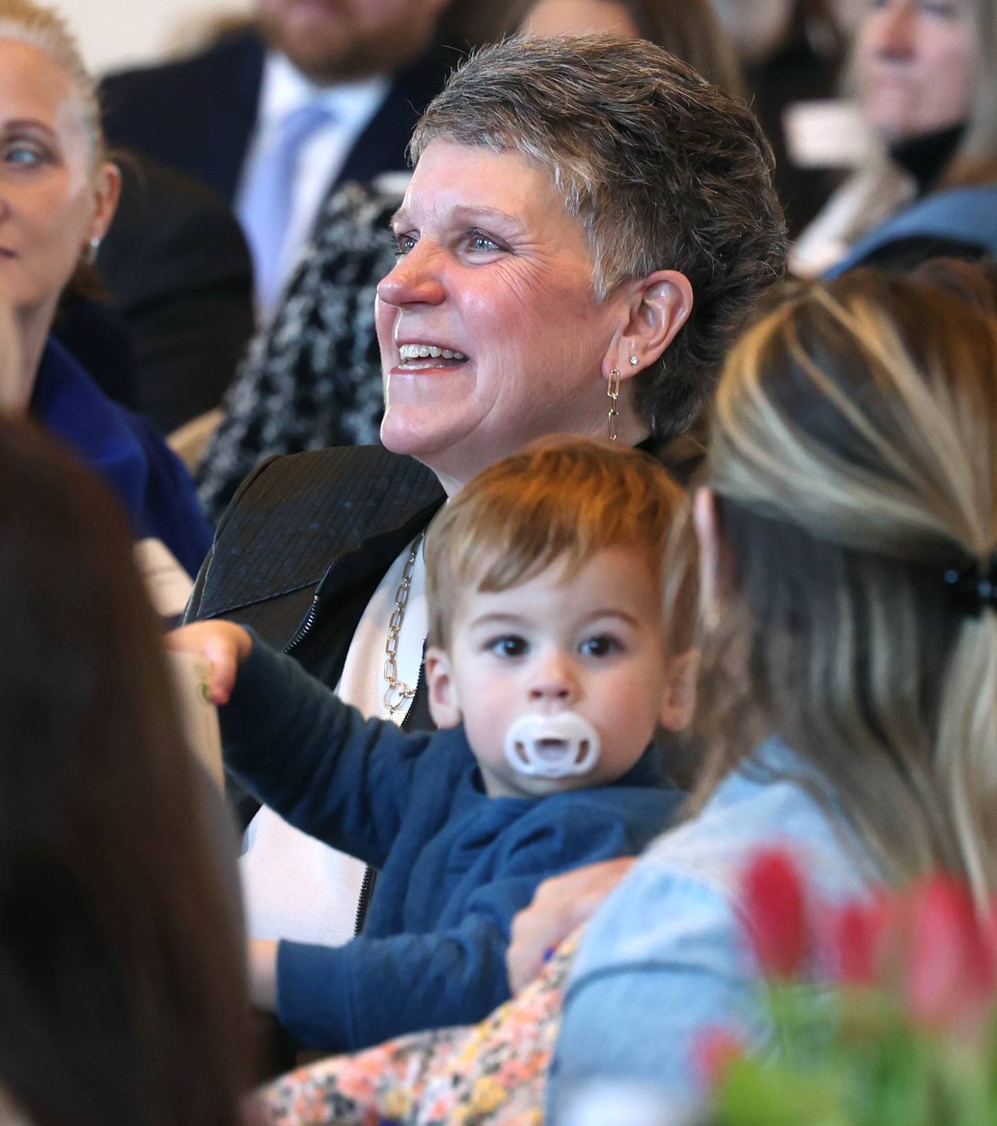 Michelle Schulz, who owned and operated Kar-Fre Flowers along with her sister Kris Wrenn (not pictured), smiles as she and her sister are introduced as the winners of the Clifford Danielson Outstanding Citizen Award during the Sycamore Chamber of Commerce Annual Meeting Thursday, March 6, 2025, at St. Mary's Catholic Church in Sycamore.