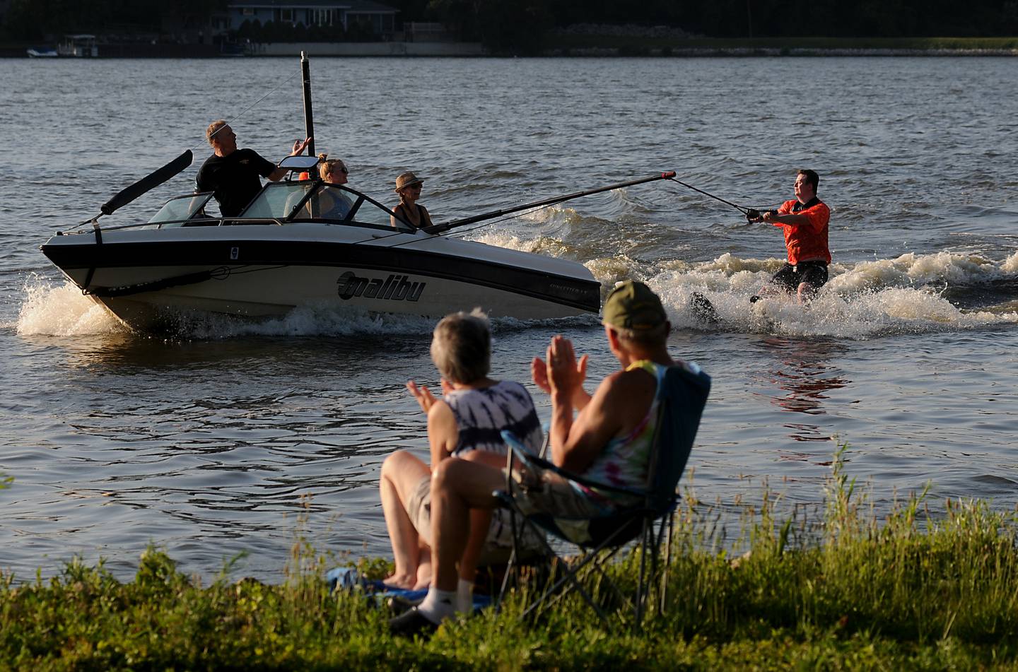 People cheer as Sam Lenihan water skis on Tuesday, June 21, 2022, while performing in the Wonder Lake Water Ski Show Team and Northern Illinois Special Recreation Association’s show on Wonder Lake. The performance was the end of the team’s learn to ski clinic. Members of ski team have constructed adaptive water ski equipment, which has proven year after year to be successful in allowing every participant to be able to water ski.