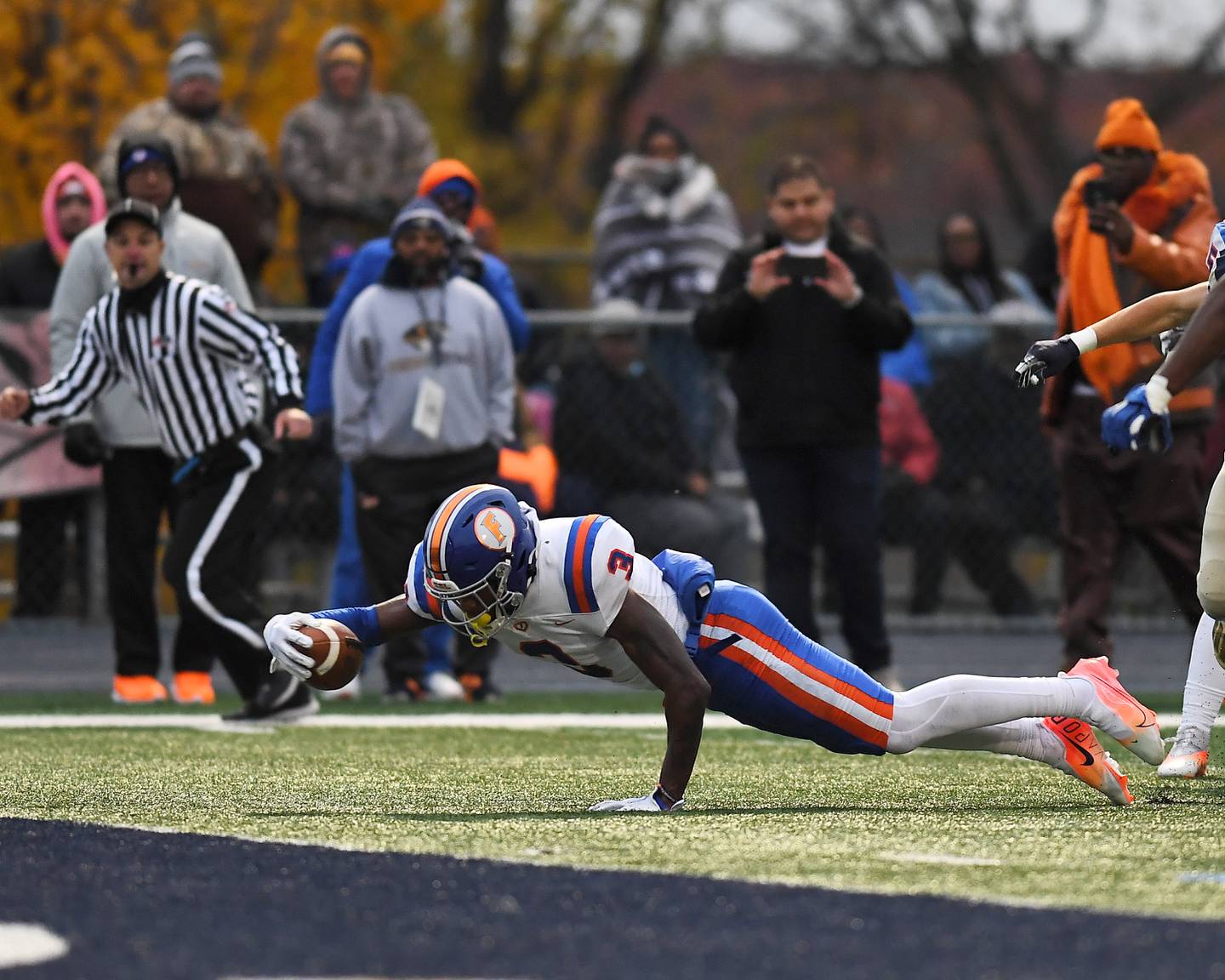 East St. Louis' Luther Burden III (3) dives for the first down during Class 6A quarterfinal playoff game on Saturday, Nov. 13, 2021, at Lemont High School.