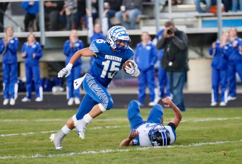 Princeton's Augie Christiansen runs past a Peotone Blue Devil Friday night at Bryant Field. The Tigers won 56-28.