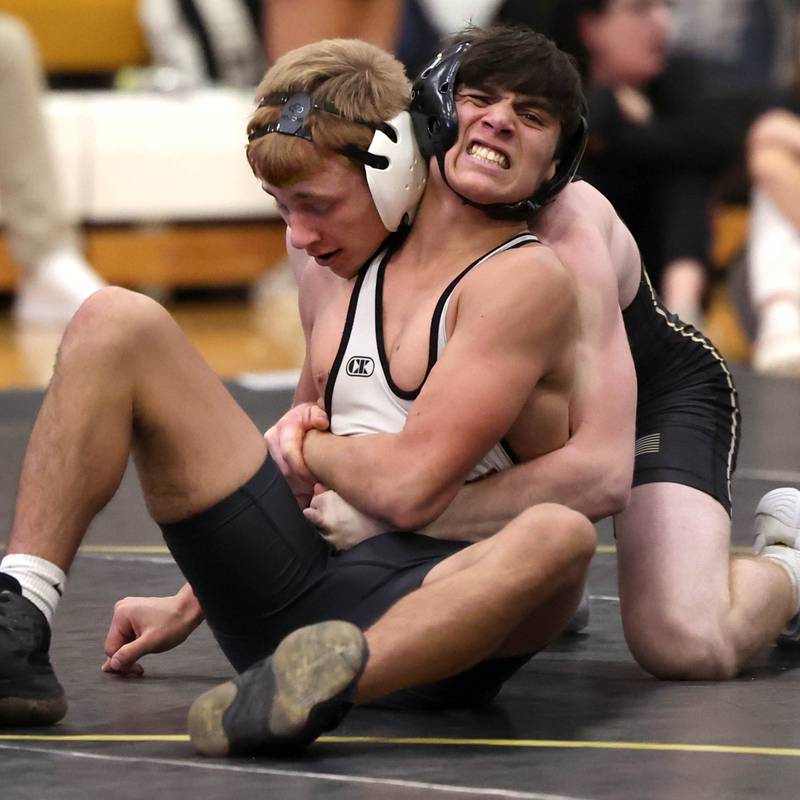 Sycamore’s Thomas Lind (left) wrestles Kaneland’s John Havron during their 132 pound match Thursday, Jan. 9, 2025, at Sycamore High School.