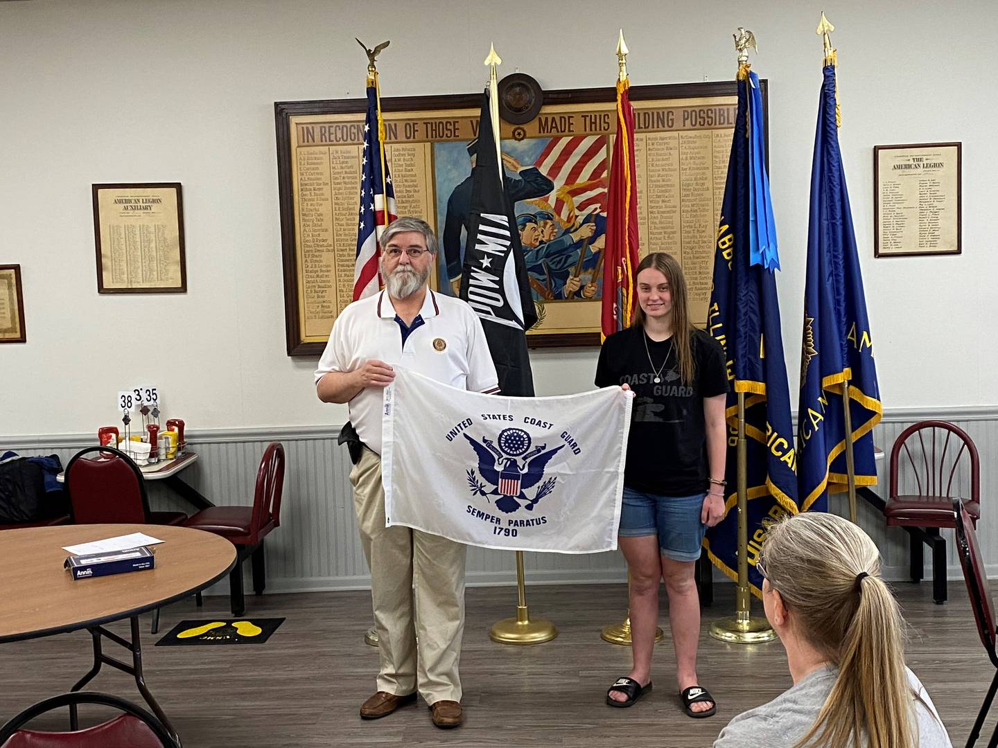 Cailey Danek, from Morris (right), with American Legion Commander Ken Buck. Danek leaves for basic training to join the Coast Guard in July.