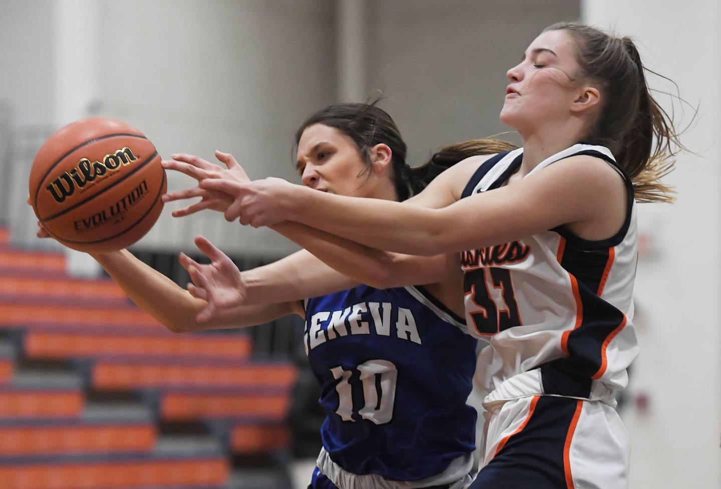 Geneva’s Peri Sweeney and Naperville North’s Ema Gilvydis battle for the ball in a girls basketball game in Naperville on Tuesday, Nov. 28, 2023.