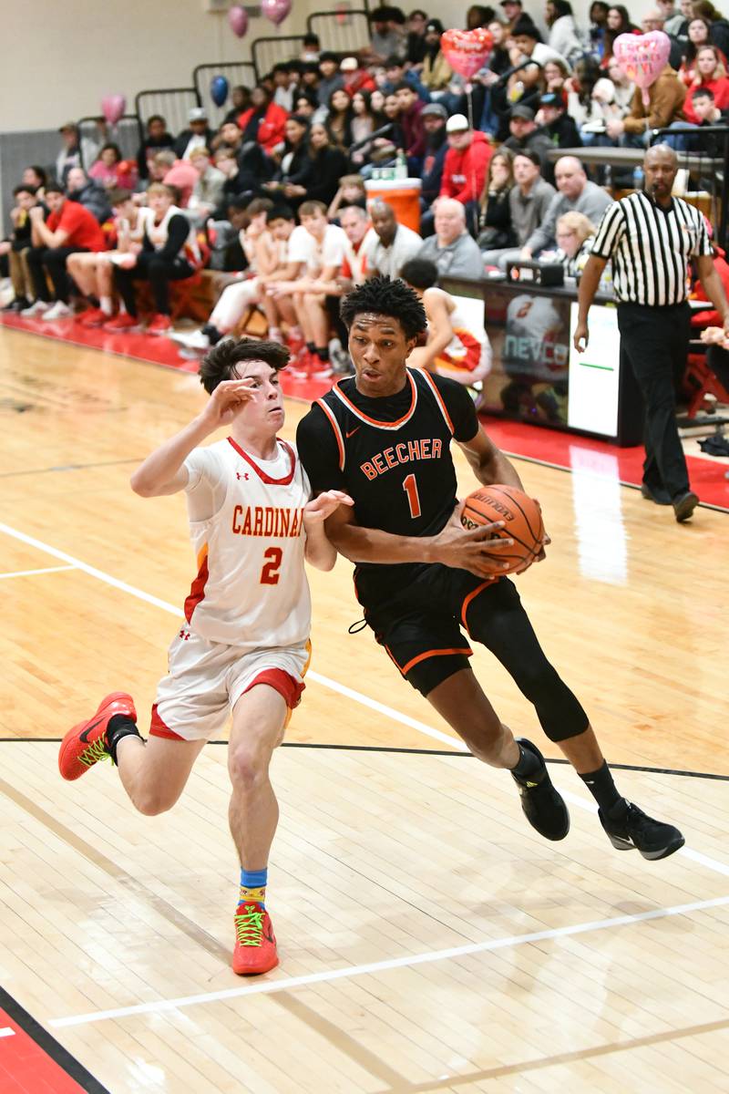 Beecher's Orlin Nesbitt drives to the lane against St. Anne's Matthew Langellier on Friday, Feb. 14, 2025, during the Cardinals' 70-38 victory over Beecher in the River Valley Conference championship.