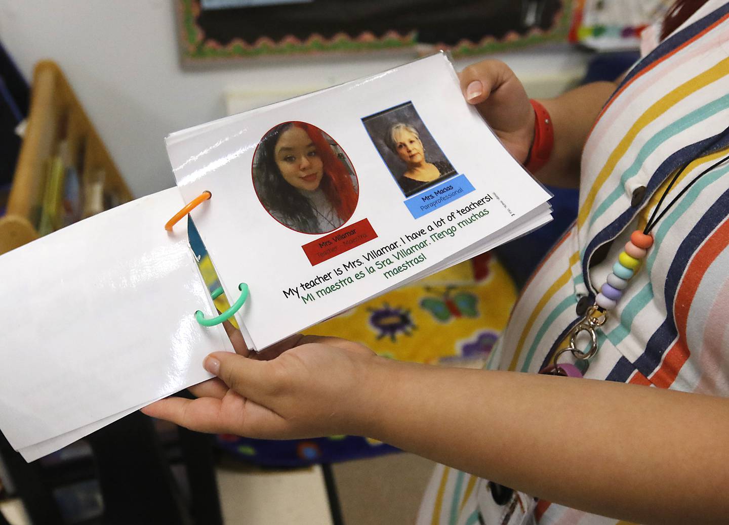 Yasmin Villamar with one of the books she makes to help students adapt to the classroom at the deLacey Family Education Center in Carpentersville on Thursday, April 20, 2023.