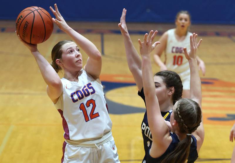 Genoa-Kingston's Ally Poegel shoots over two Polo defenders during their game Monday, Jan. 29, 2024, at Genoa-Kingston High School.