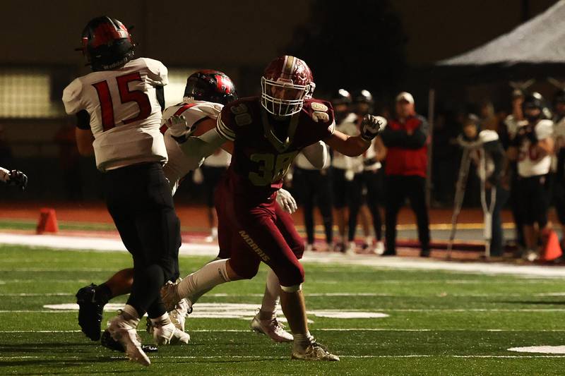 Morris’ Hayden Hutchcraft puts pressure on Highland’s Blake Gelly on Saturday, Nov. 9, 2024 in Morris.