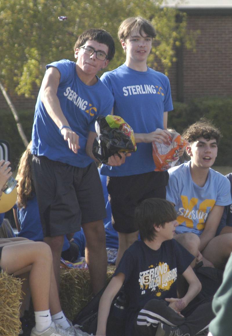Sterling Cross Country runners toss candy to the large rowd. The parade took place on Friday afternoon, October 3rd, 2025, prior to the HC football game.