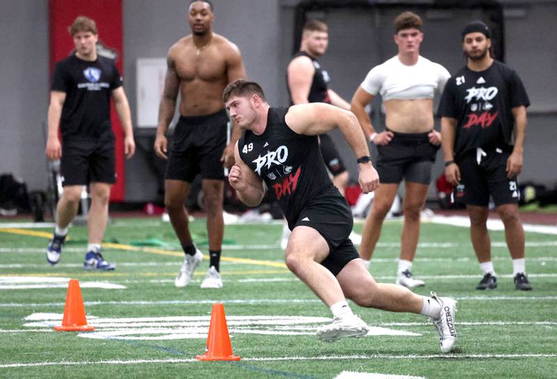Former Northern Illinois University fullback Brock Lampe runs a shuttle drill for NFL scouts as others wait for their chance during pro day Monday, March 17, 2025, in the Chessick Practice Center at NIU in DeKalb.