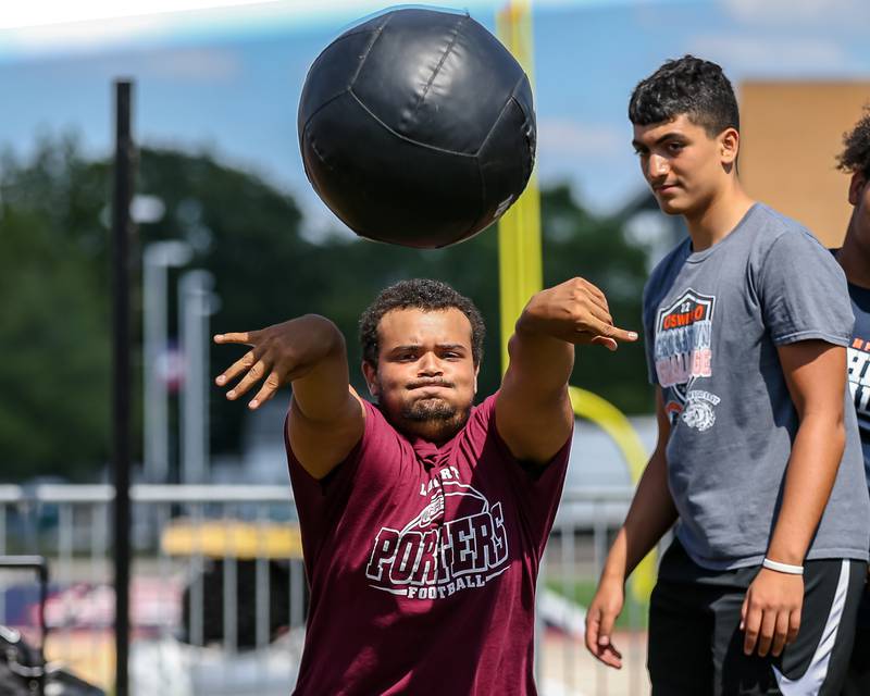 Lockport competes in the weighted ball toss at the West Aurora High School Battle of the Big Butts Linemen Challenge.  July 14, 2022.