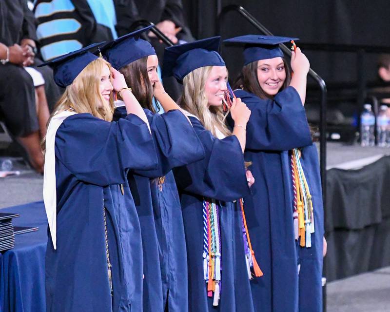 Members of the Oswego High School senior class help lead the turning of the tassels during the graduation ceremony on Saturday May 17, 2025, held at the Convocation Center in DeKalb.
