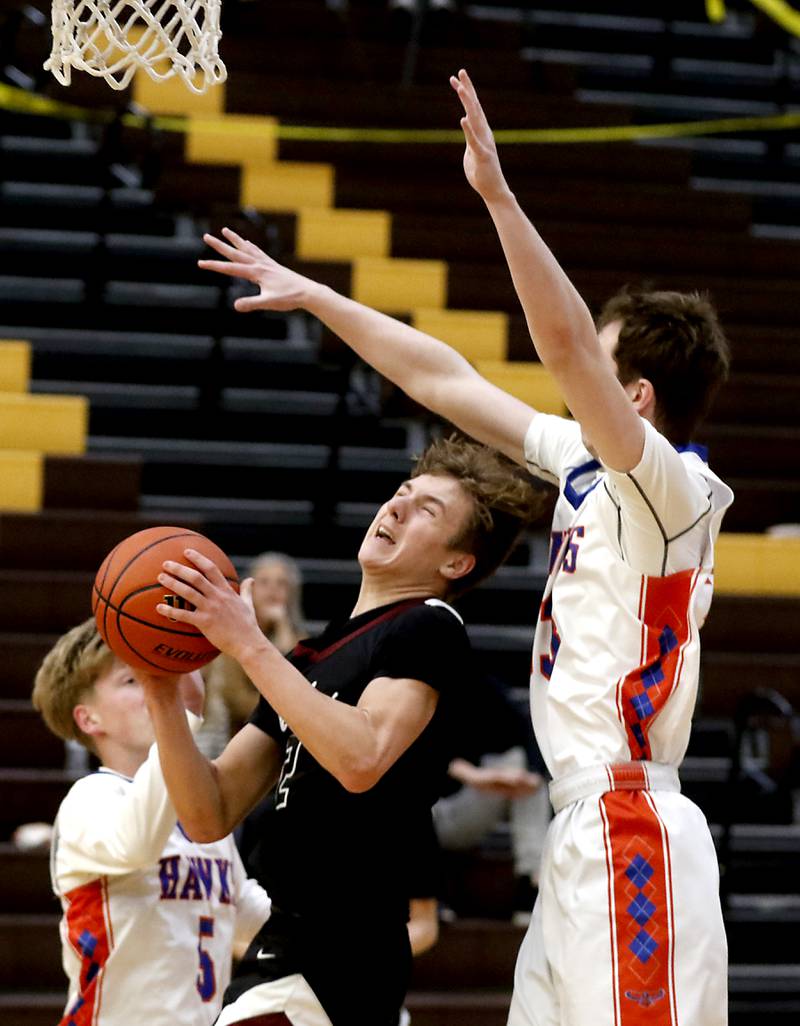 Prairie Ridge's Drake Tomasiewicz is fouled by Hoffman Estates’ Abell Bosnjak as he drives to the basket during a Hinkle Holiday Classic basketball game Wednesday, Dec. 28, 2022, at Jacobs High School in Algonquin.