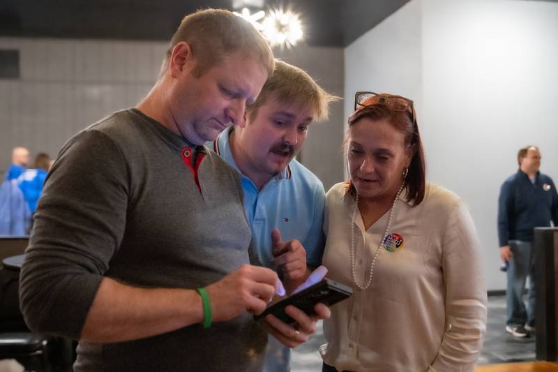 State Representative Candidate Amy “Murri” Briel (Right) checks live polls with Jedge (Middle) & Steve Slothower on Tuesday, November 5, 2024 at Alfano’s in Ottawa.