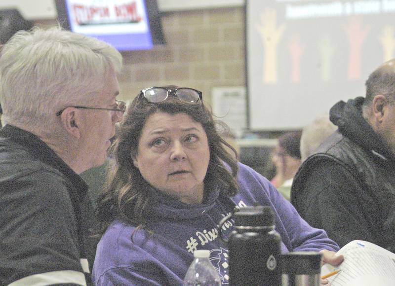 Team members Rena Metzler and Kris Bake discuss an answer at the Stupor Bowl on Saturday, Feb. 8, at Reagan Middle School in Dixon.