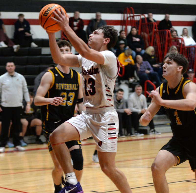 Forreston's Kendall Erdmann (13) drives to the basket against Riverdale on Friday, Dec. 27, 2024 at the Cliff Warkins Memorial Basketball Tournament at Erie High School.