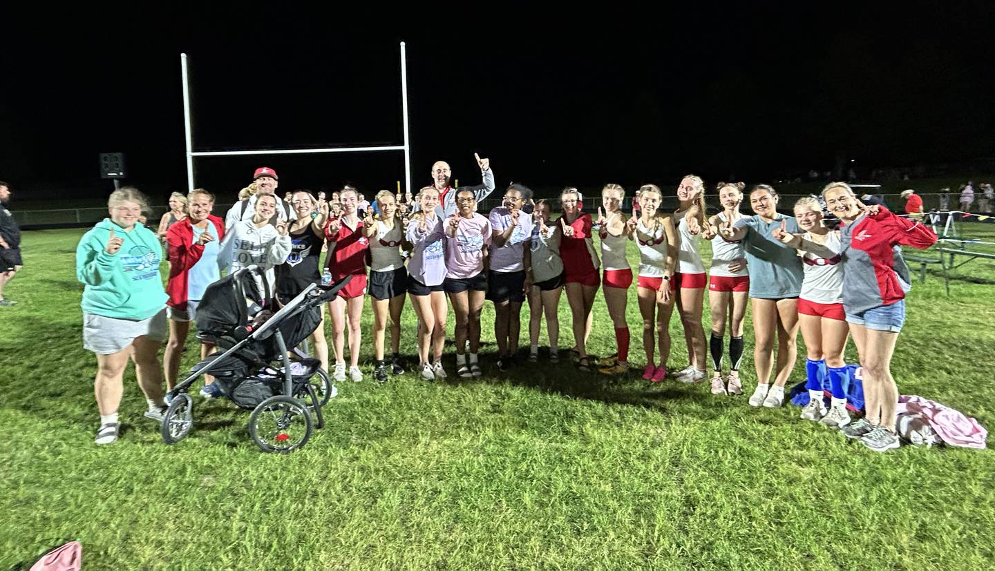 Oregon track and field team members and their coaches celebrate after winning the 1A Lena-Winslow sectional on Thursday, May 15, 2025.