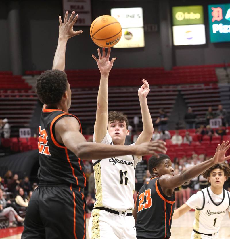 Sycamore's Jake Shipley shoots the ball over DeKalb's Justin O’Neal during their game Friday, Jan. 31, 2025, in the FNBO Challenge in the Convocation Center at Northern Illinois University in DeKalb.