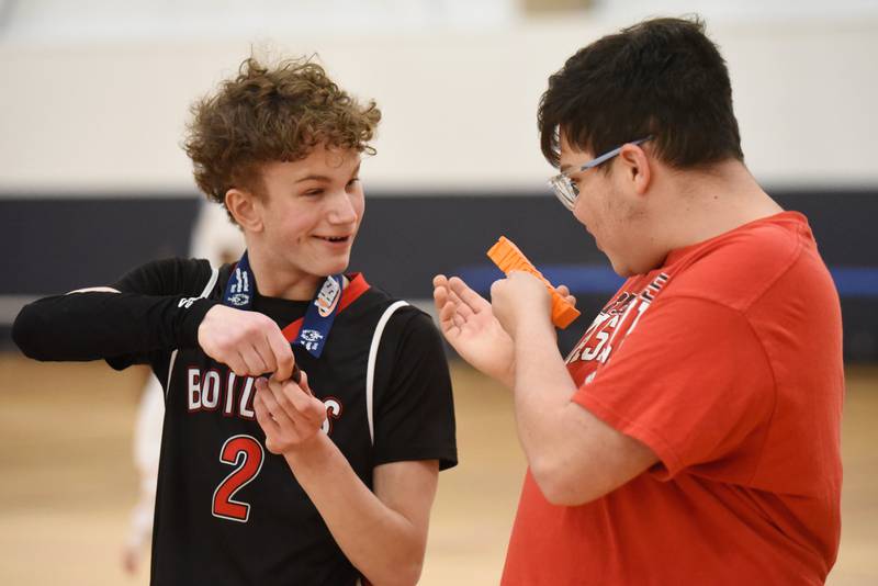 Bradley-Bourbonnais' Nathan Corder, left, shows his IHSA Class 2A Special Olympics Unified second-place medal following the Boilermakers' 44-36 loss to Vaughn/St. Patrick at the University of Illinois Activities and Recreation Center Saturday, March 14, 2026.