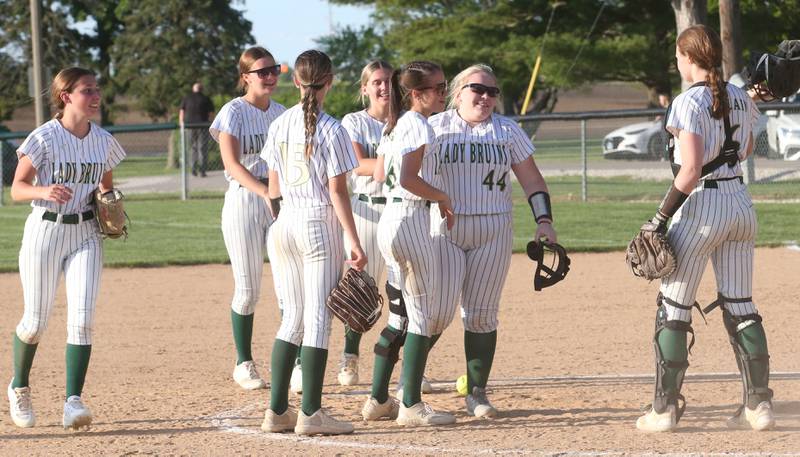 Members of the St. Bede softball team gather at the mound after defeating Illinois Valley Central during the Class 2A Regional final on Friday, May 23, 2025 at St. Bede Academy.