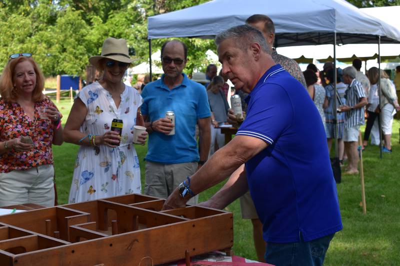 A guest at the 2022 Apple-Bee at the Durant House Museum playing skittles.