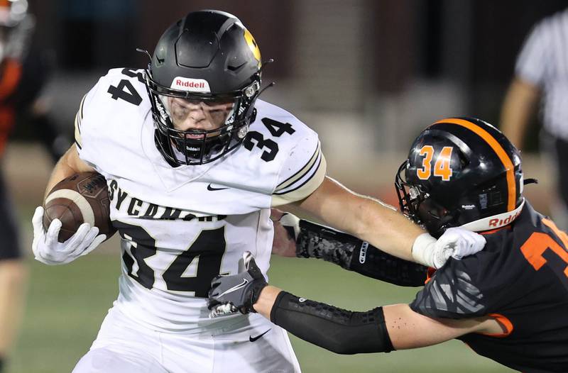 Sycamore's Joey Puleo sheds the tackle of DeKalb's Austin Martin during the First National Challenge Friday, Aug. 26, 2022, in Huskie Stadium at Northern Illinois University in DeKalb.