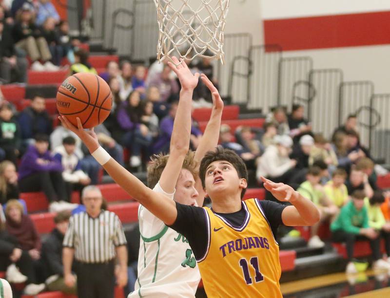 Mendota's Iziah Nenez scores on a layup over Rock Falls's Aydan Goff during the 49th annual Colmone Classic on Friday, Dec. 8, 2023 at Hall High School.