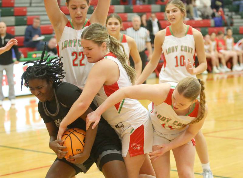 Kaneland's Amani Meeks takes the ball away from L-P defenders Emma Jereb and Elizabeth Sines on Wednesday, Jan. 15, 2025 in Sellett Gymnasium at L-P High School.