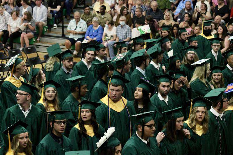 The Rock Falls High School graduating class of 2022 scan the crowd at Tabor Gym for family members before the start of  commencement exercises on Sunday.