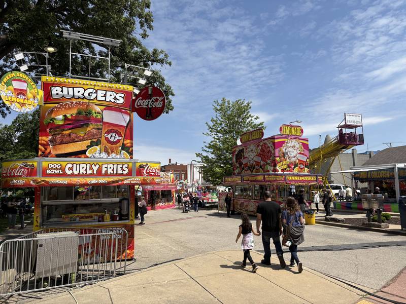 Visitors make their way through Hickory Street to sample a variety of food options Saturday, May 24, 2025, during Park Fest at City Park in Streator.
