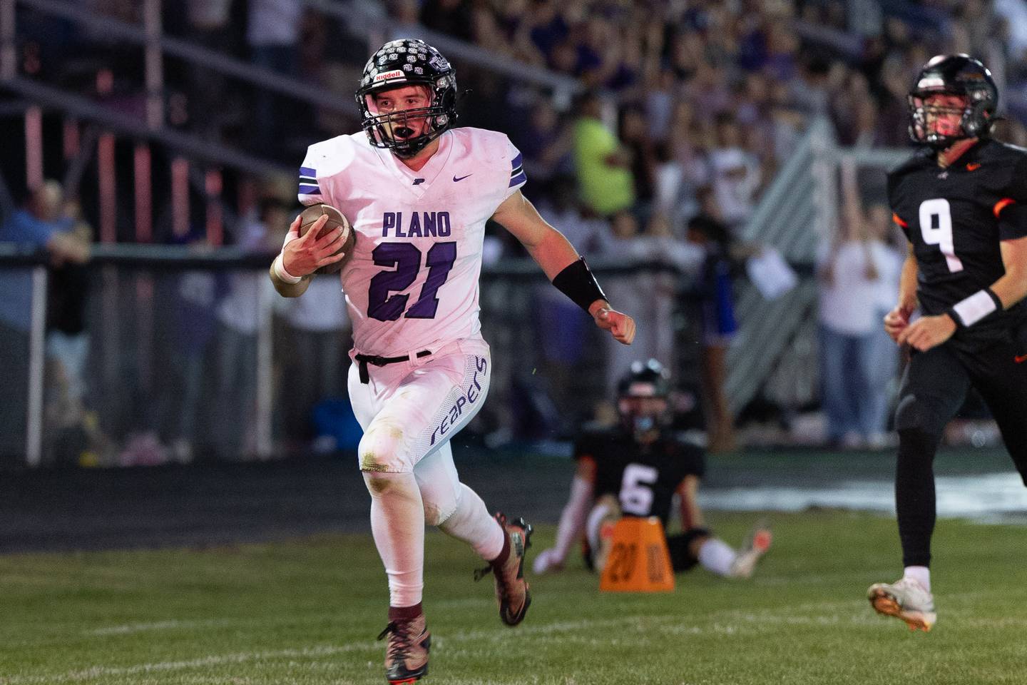 Plano's Kolten Schimandle runs in a long touchdown during Friday's game with Sandwich in Sandwich.