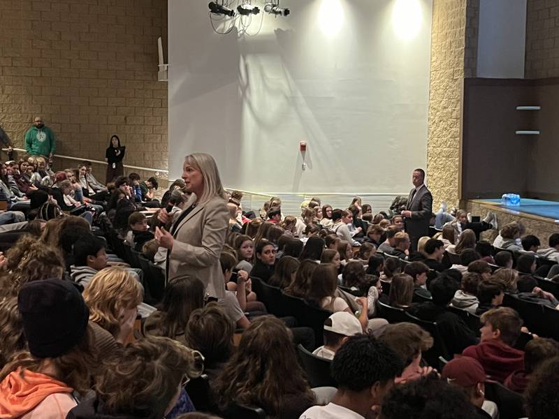 McHenry County Judges Jennifer Johnson, standing in foreground, and Justin Hansen standing near stage, speak to freshmen and sophomores at Prairie Ridge High School in Crystal Lake on Oct. 16 about legal hazards of social media and cellphone use.