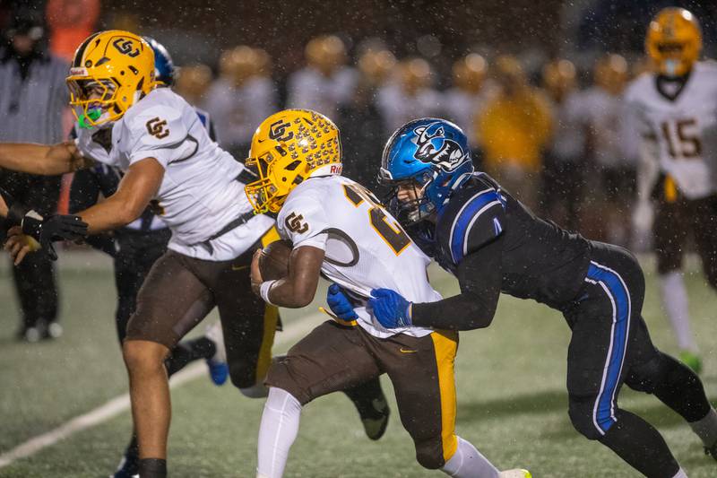 St. Charles North's Wyatt Brandt tackles Carmel's Vinny Fiore at the Class 7A Second Round playoff game on Saturday, Nov.8,2025 in St. Charles.