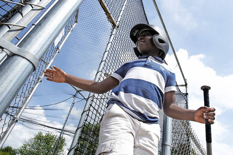 Daniel Adekeye of Crystal Lake, 8, exits the batting cages at Lippold Park on Thursday, June 4, 2015, in Crystal Lake.