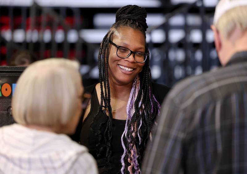 Sha Hill, with Family Service Agency, talks to attendees at their booth Thursday, April 24, 2025, during the Local Showcase and Spring Show in the Convocation Center at Northern Illinois University in DeKalb.