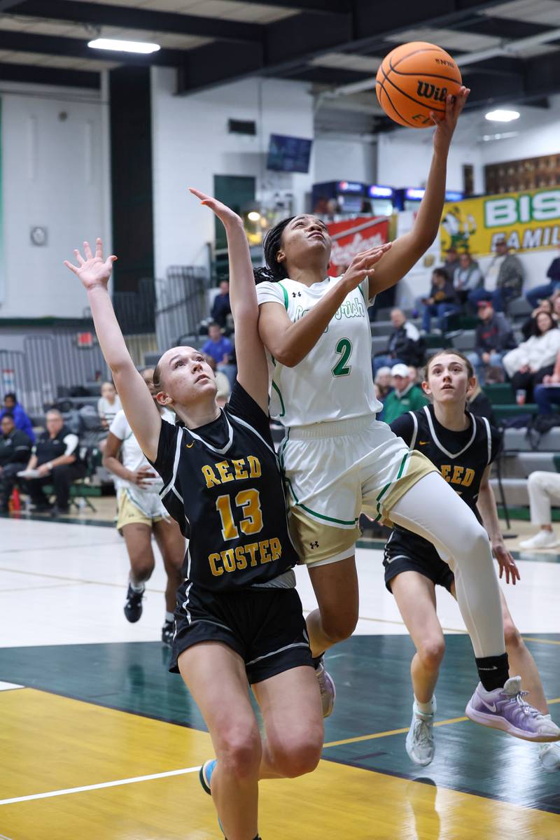 Bishop McNamara's Hailey Jackson goes for a layup against Reed-Custer's Atiana Hood during Bishop McNamara's 60-36 victory over Reed-Custer in the IHSA Class 2A Bishop McNamara Regional semifinals on Monday, Feb. 16, 2026.