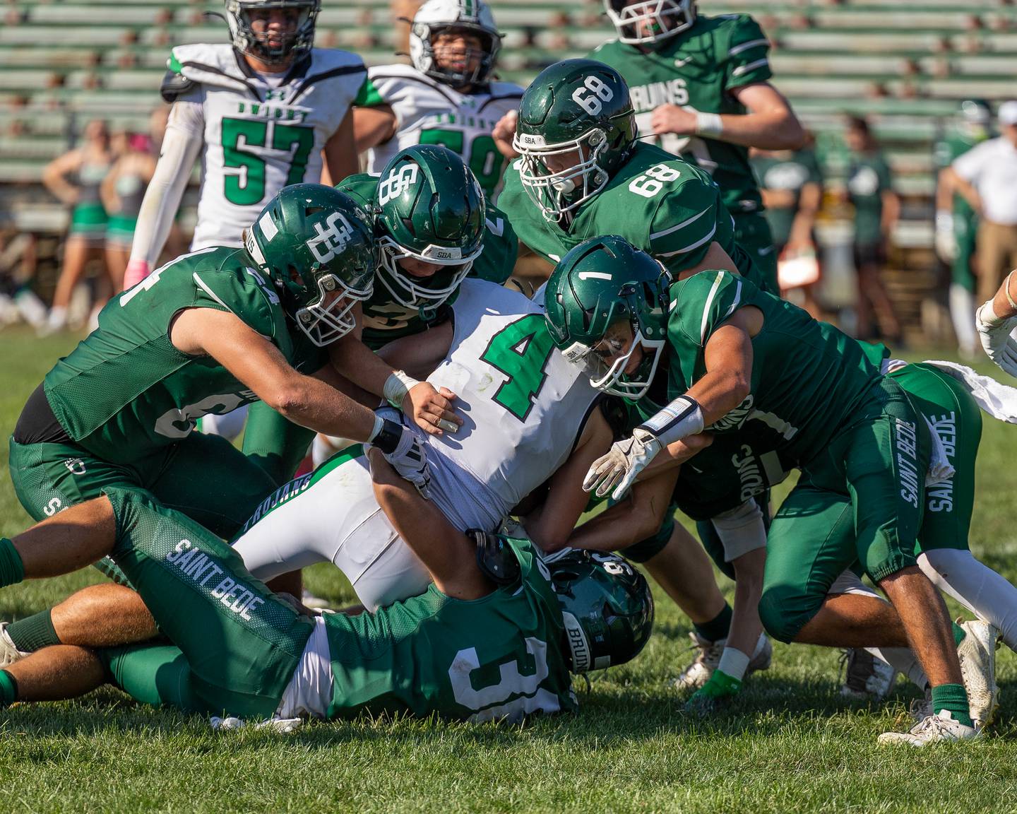 Kayden Wood (4) of Dwight is surrounded by St. Bede defense as they bring him down in tackle on Saturday, Oct. 4, 2025 at Captain Thomas J. Heitmann field in Peru.