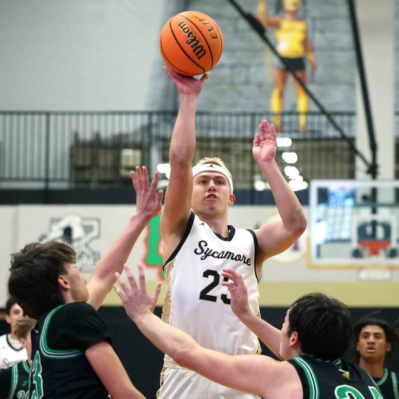 Sycamore's Carter York shoots a floater in the lane between two North Boone defenders during their game Tuesday, Dec. 3, 2024, at Sycamore High School.