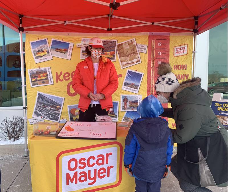 Brandon Mazzaferro of Crystal Lake and the driver of the Oscar Mayer Wienermobile visits with customers outside Mariano's in Crystal Lake on Sunday, Jan. 16, 2022.